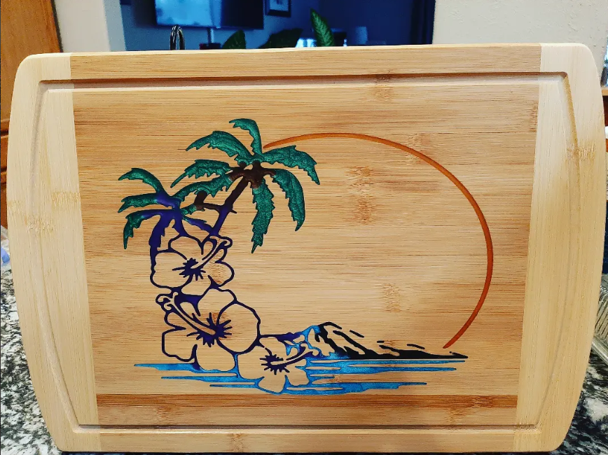 Beach-inspired handmade charcuterie board with blue resin wave detail