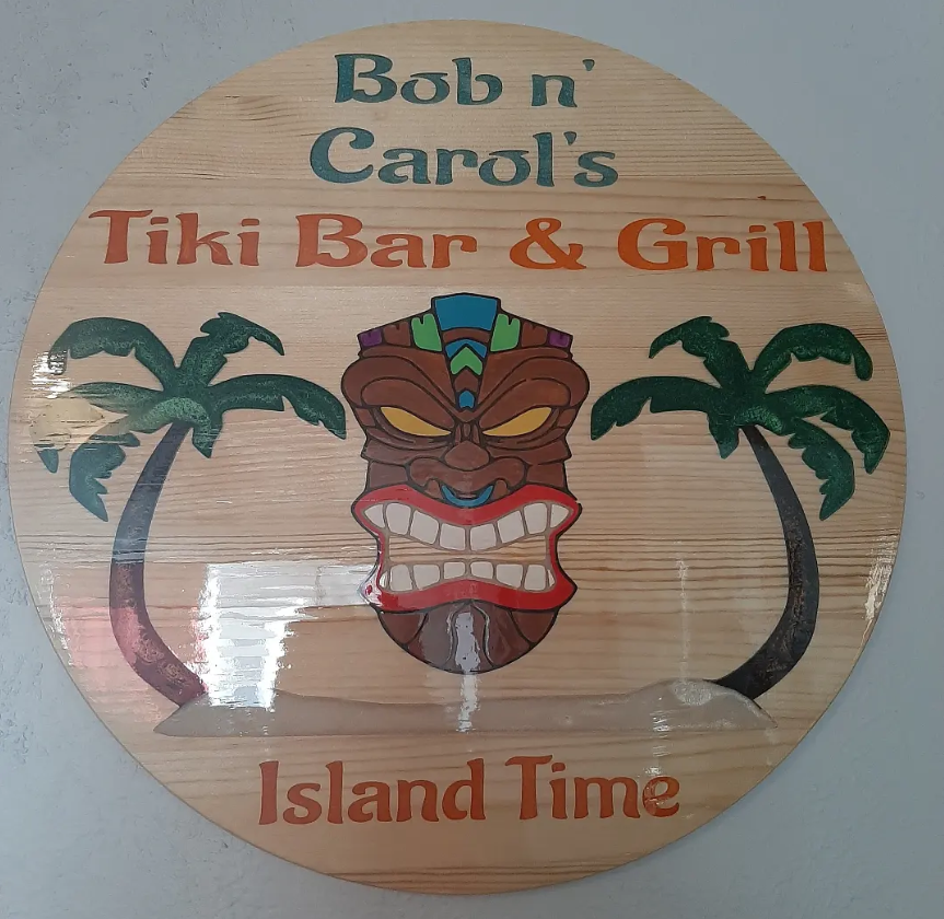 Custom handmade bar sign with wood, engraved detail, and artistic finish