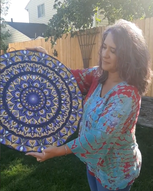 Artist with a handmade mandala art piece from 5280 Sawdust and Ink